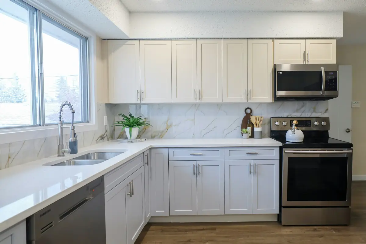 White kitchen with steel appliances